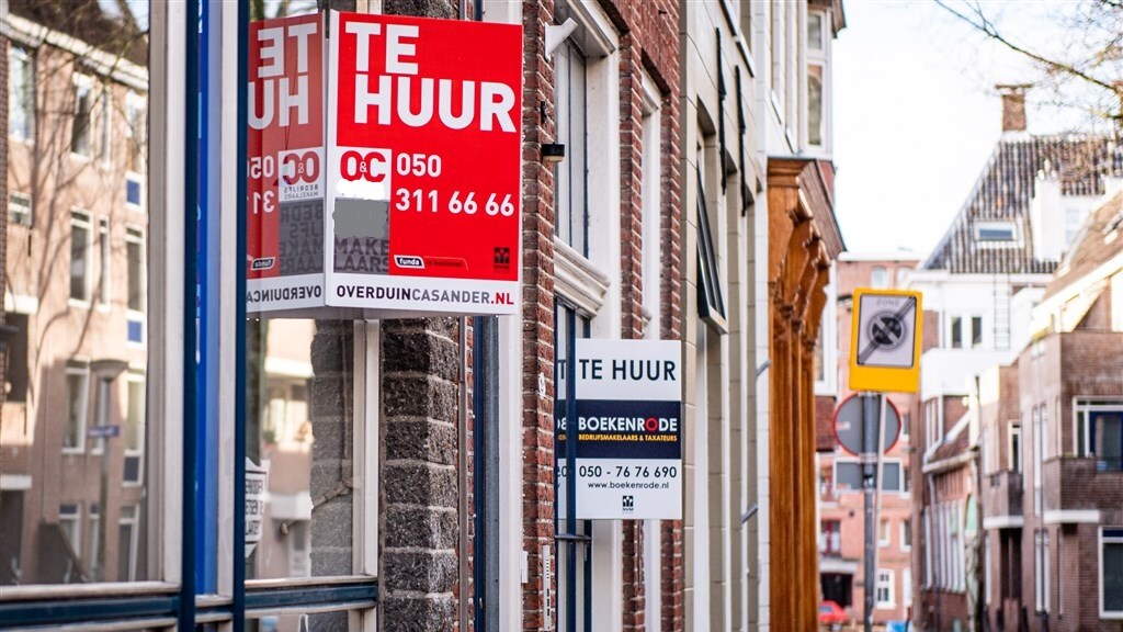 houses with for rent signs in a dutch street